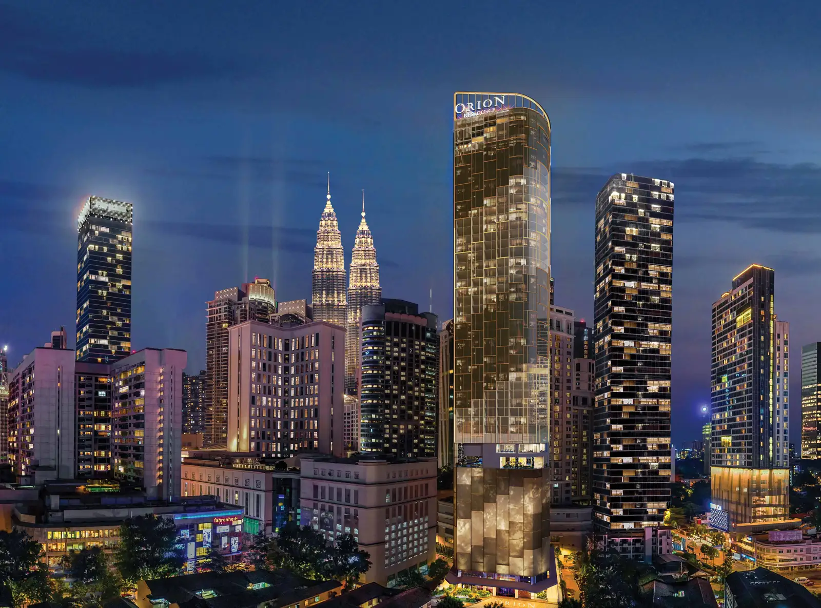 Orion Residence tower at night within the Kuala Lumpur skyline